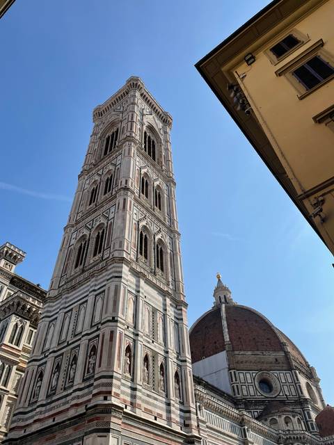       Giotto's Campanile in Florence with bright blue sky.
  
