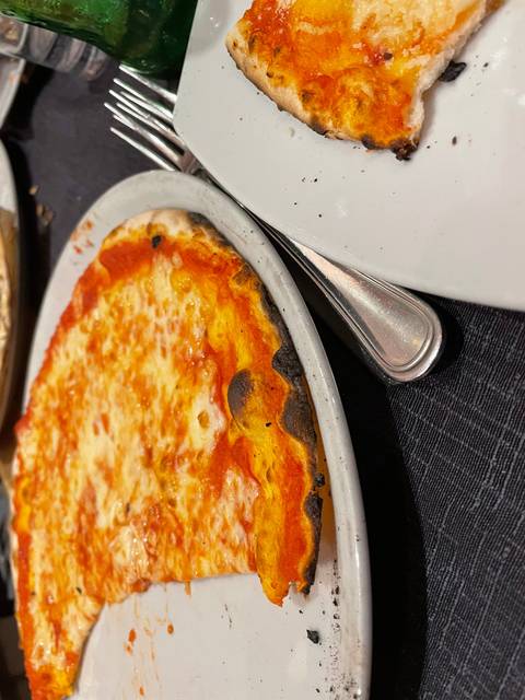       Slice of Margherita pizza on a white plate.
  