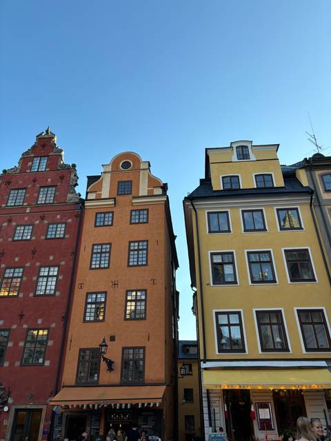       Colorful buildings with clear blue sky in the background.
  
