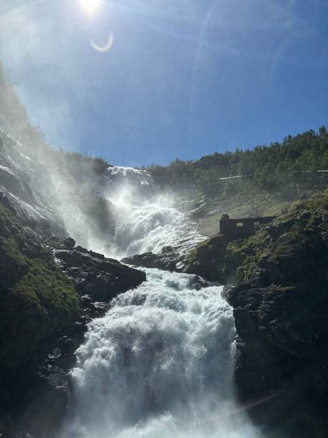       Powerful waterfall among rocky terrains.
  