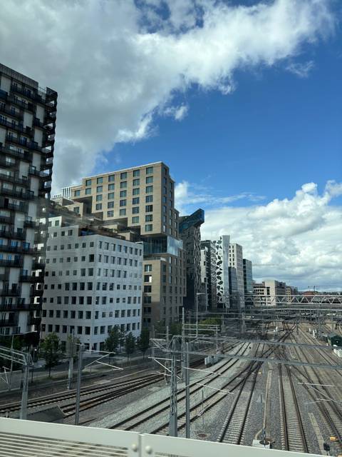      Modern architecture alongside railway tracks.
  