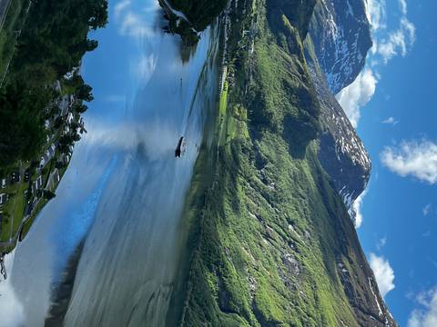       A fjord landscape with snow-capped mountains.
  