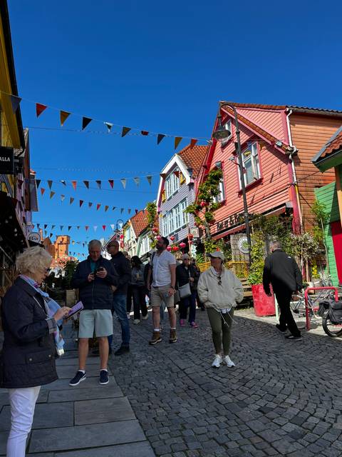       Street scene with colorful buildings and people.
  