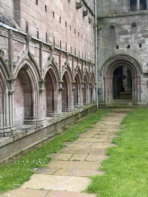       Stone ruins and green grass.
  