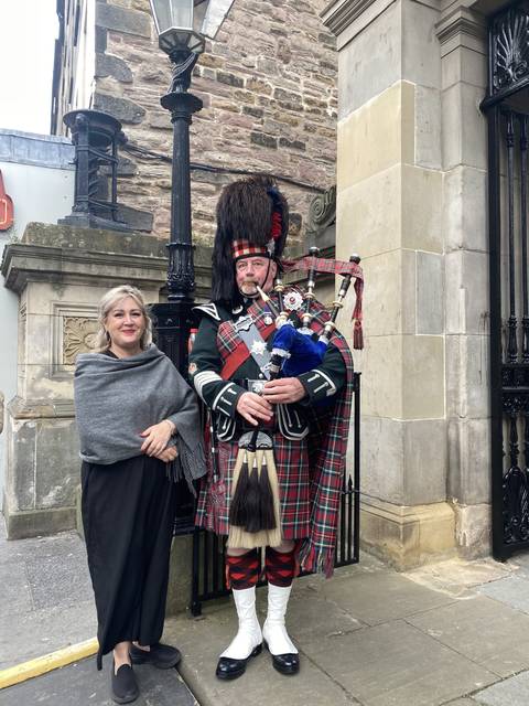       Person in traditional Scottish attire, bagpipes visible.
  