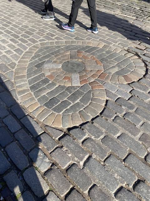       Patterned paving stones with feet.
  