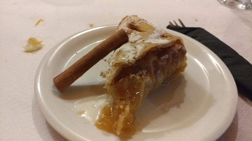       Small plate with dessert and cinnamon stick.
  
