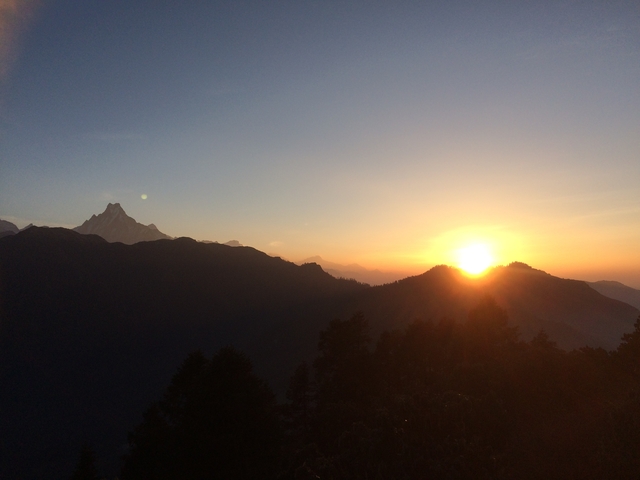 Sunset over the mountains in Nepal with a clear sky.