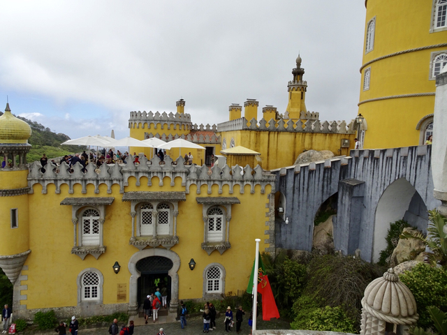 Pena Palace with detailed architecture and tourists.
