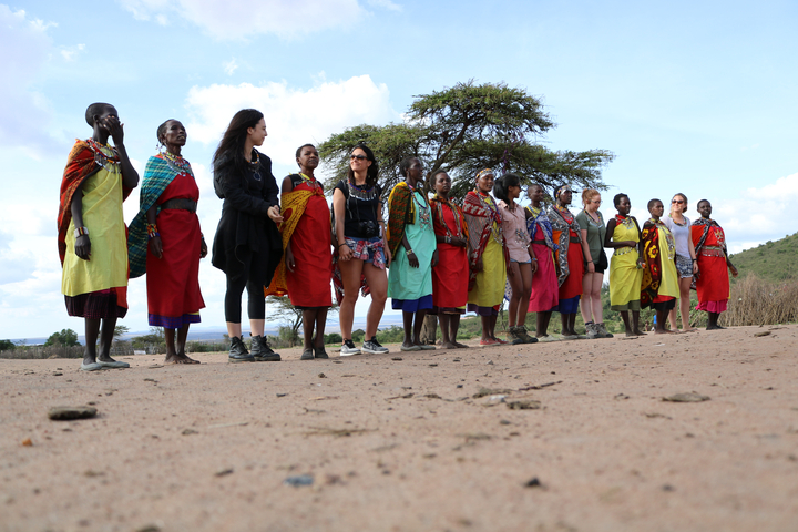 Group of people and locals wearing traditional attire.