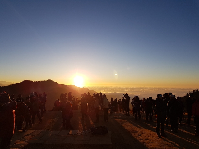 People gathered on a mountain to watch the sunrise.