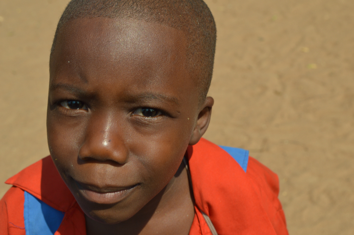 Close-up of a child smiling at the camera.
