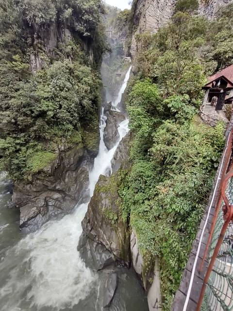 Waterfall cascading through a lush canyon.