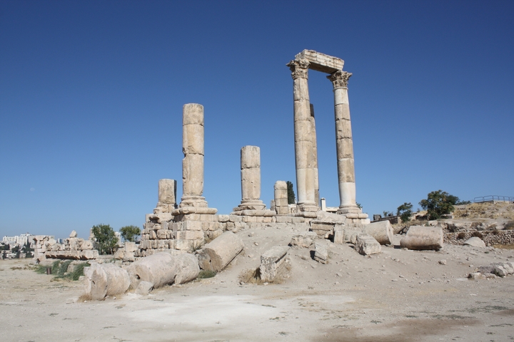       Ancient stone columns in a historical ruin setting.
  