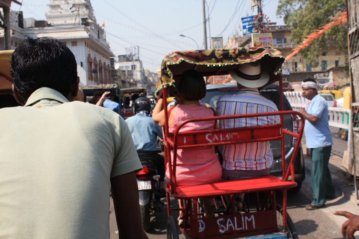 View from a rickshaw of a crowded street.