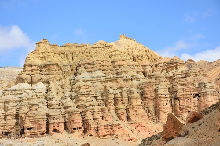       Eroded rock formations with sky backdrop.
  