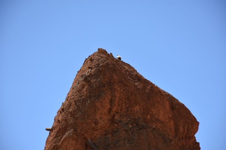       Rocky pinnacle under a clear blue sky.
  