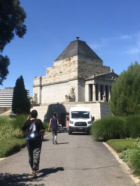       Building with a path and grassy area, viewed from an angle.
  