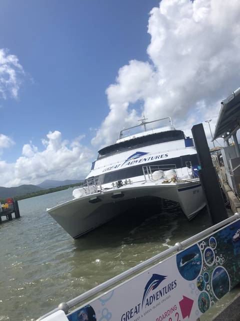 Boat docked near shore with a view of clouds