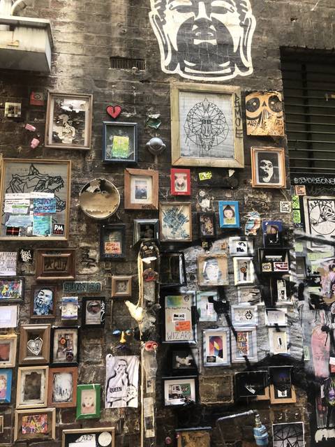       Wall covered with various artworks and frames
  