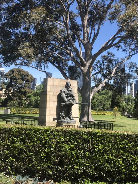       Statue in a garden with a tree
  