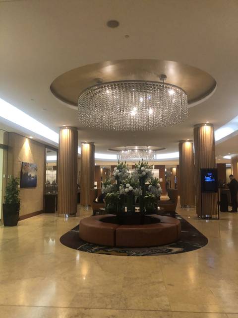       Lobby of a hotel with a chandelier
  