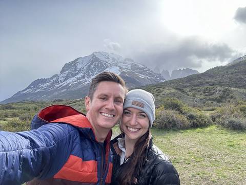 Upside-down photo of a couple with snow-capped mountains.