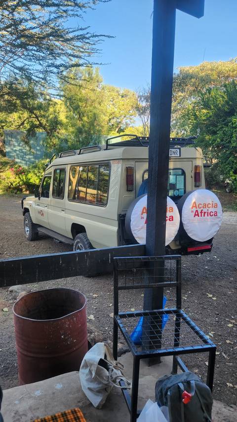 Parked vehicle with 'Acacia Africa' branding.