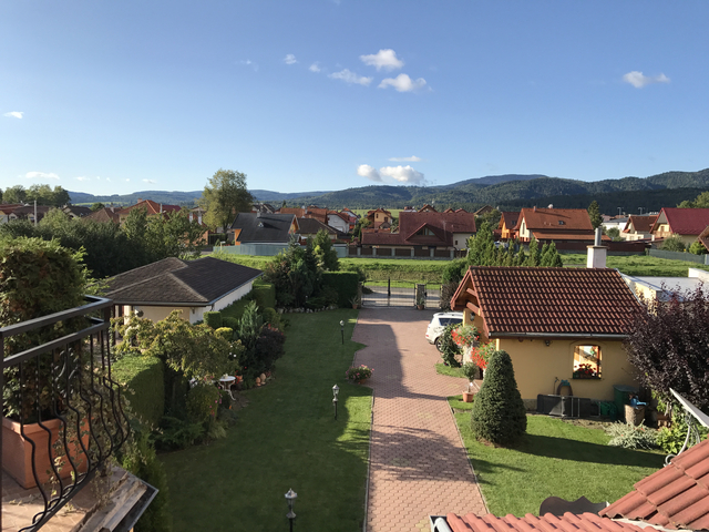 View of a residential area with mountains in the background.