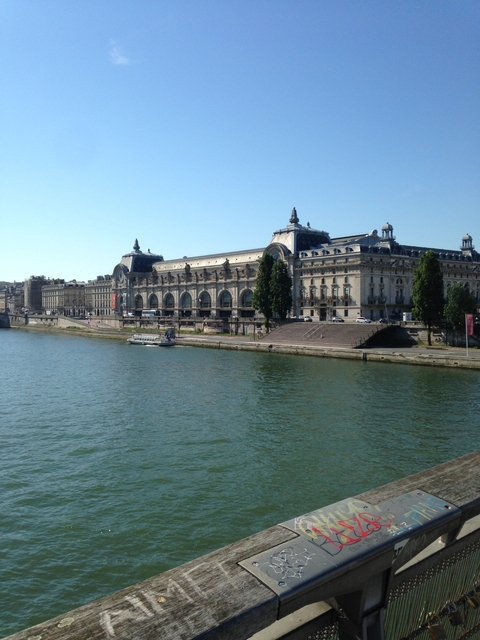       Building across a river, possibly a museum.
  