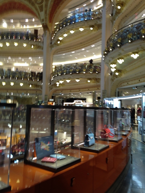       Blurry view inside a mall with stores.
  