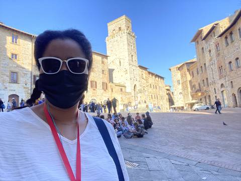 A person taking a selfie in a historic square.