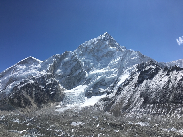 Snow-capped mountain peak against a clear blue sky.