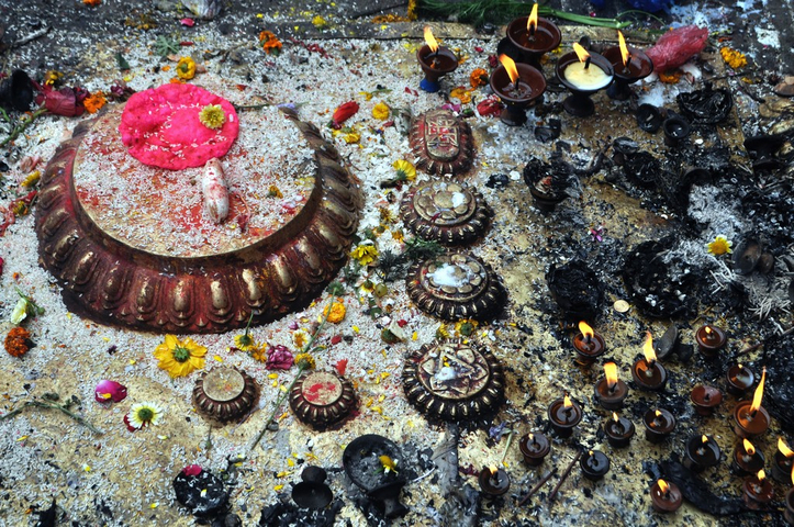       Decorative ground with arranged offerings and candles.
  