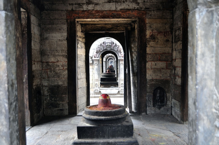       Corridor of traditional stone sculptures lining the path.
  