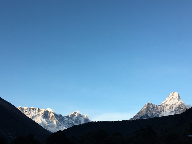 Snow-capped mountain peaks under a clear blue sky.
