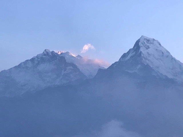       Snow-covered mountain peaks under a twilight sky.
  