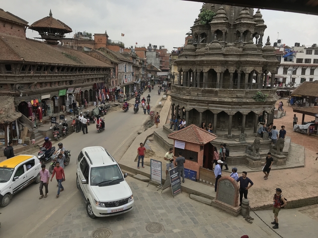 Bustling street with traditional architecture and people.
