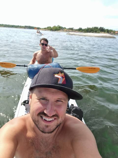       People kayaking on a body of water.
  