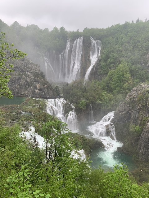       Waterfalls in a lush green national park.
  