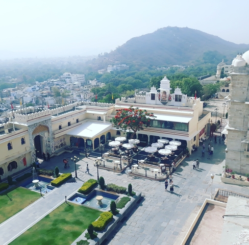       Tourist destination with a courtyard, dining area, and view of the city.
  