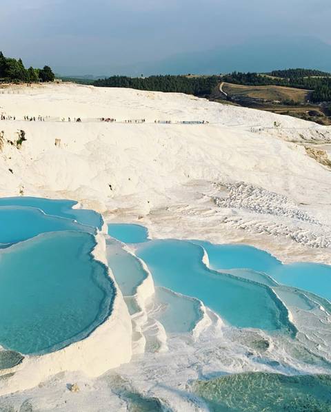       Capture of Pamukkale's white travertine terraces with pools.
  