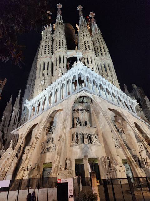       Night view of a large ornate cathedral.
  