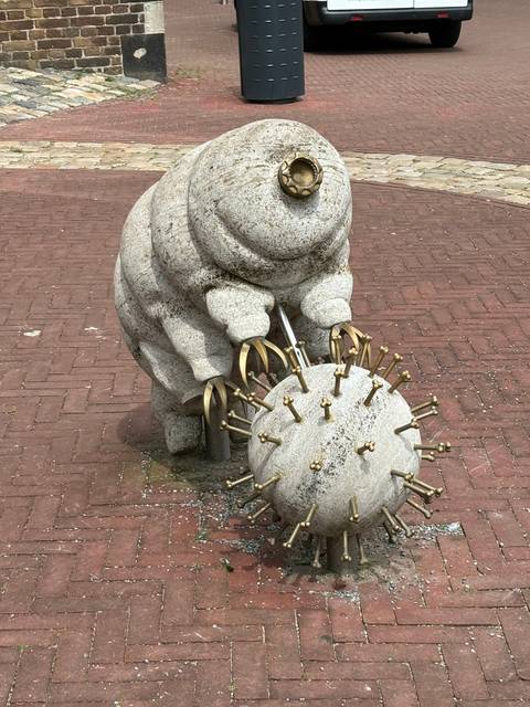       Stone sculpture in a public space with a unique design.
  