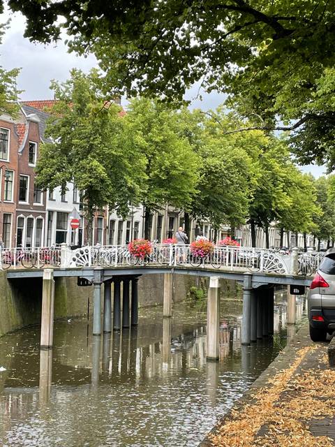       Bridge over a canal with floral decorations.
  