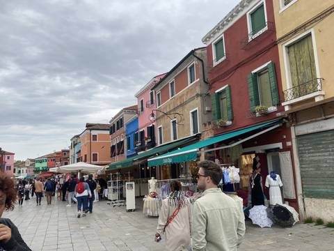 Colorful street with people and market stalls.