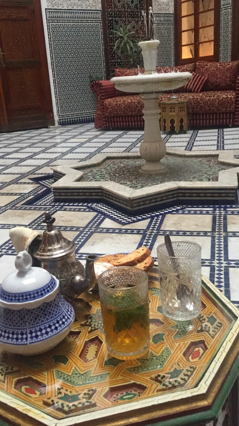       Traditional Moroccan tea set on a mosaic table.
  