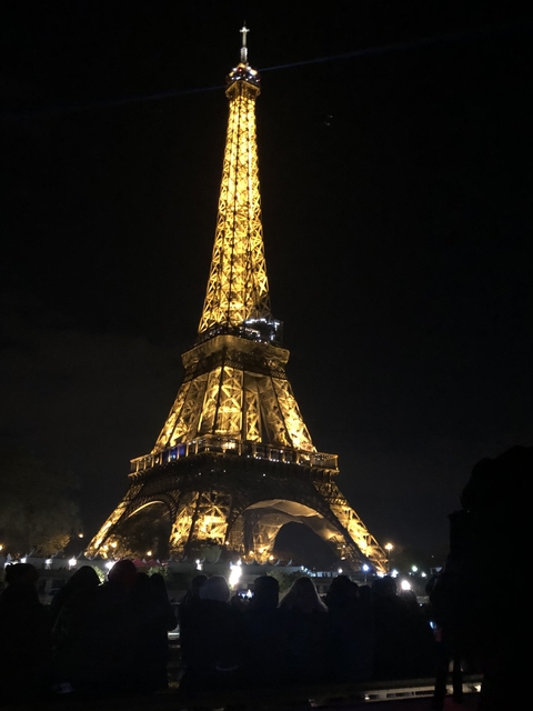 Eiffel Tower illuminated at night.