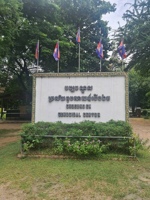 Sign with text in a garden setting.