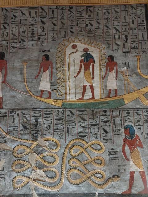 Ancient Egyptian hieroglyphs and art on a temple wall.